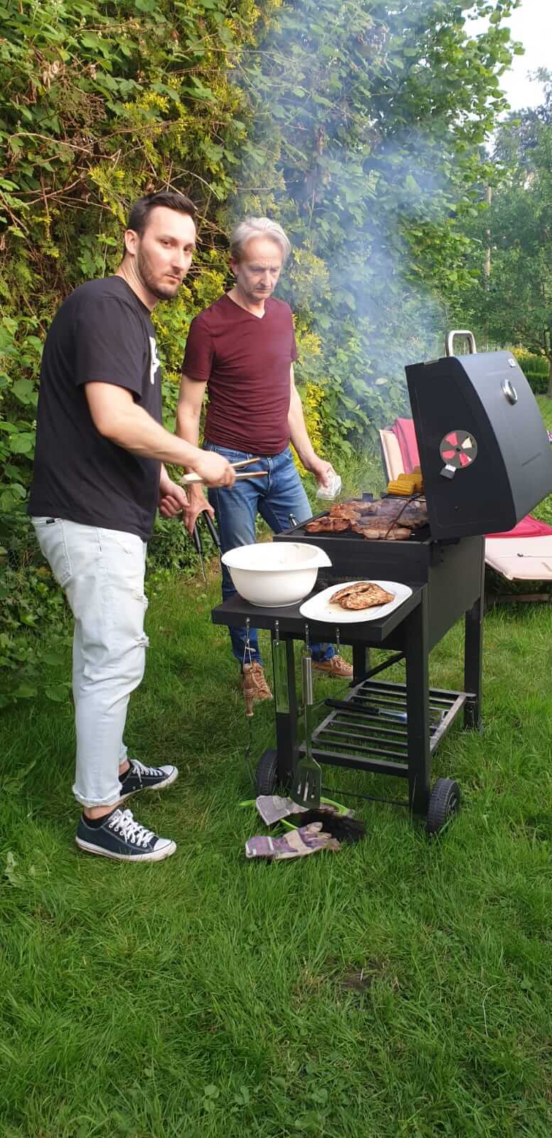 Two people barbecuing