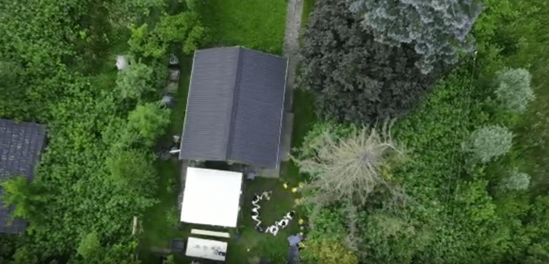 Drone video of the garden showing people dancing.